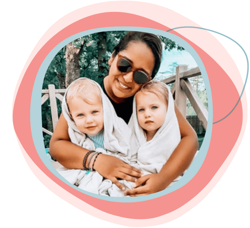 Au pair holding two infants.
