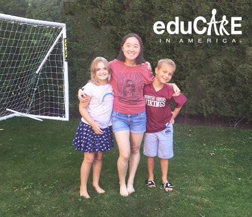 Au pair and children playing in backyard.